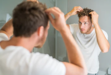 Man checking for hair loss problem